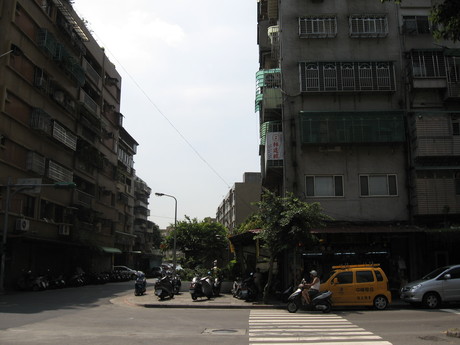 A quiet street scene showing metal window boxes