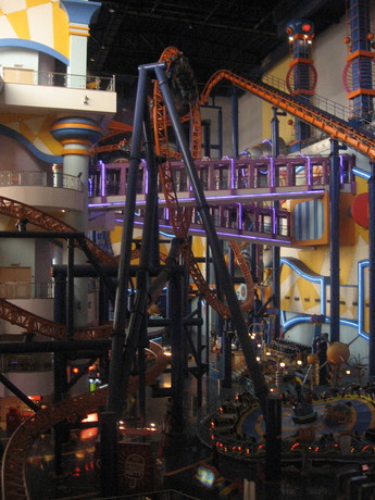 A roller coaster higher up in Times Square; note the car upside down at the top